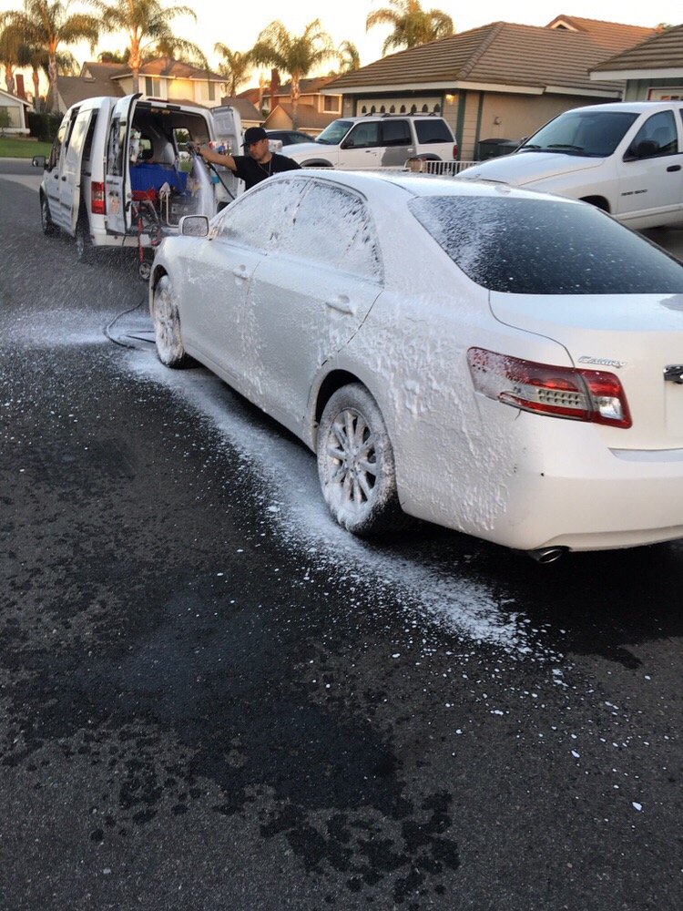Knights Mobile Detailing foam washing a Toyota Camry on a residential street