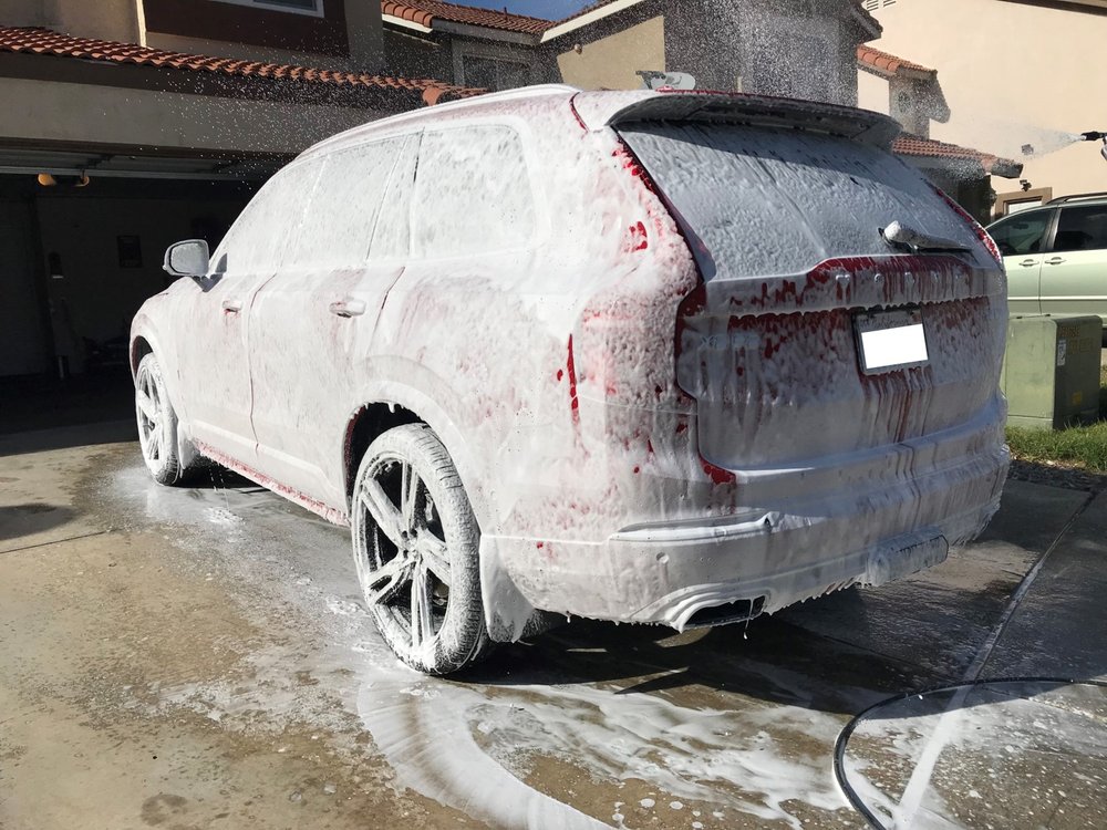 SUV getting a foam wash in a residential driveway by Knights Mobile Detailing